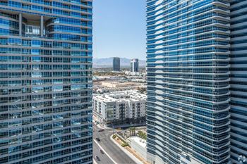 Two tall buildings with blue glass windows stand next to each other.